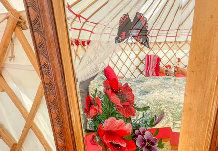 a reflection through the vintage mirror inside Poppy Yurt