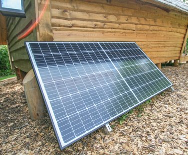 The solar panel outside Rose Hollow log cabin suppling power from the sun